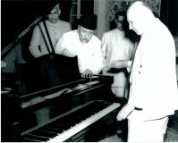 H. E. Mr. E. W. Meyar, Ambassador of the Federal Republic of Germany to Indian presented a piano to the Ministry of Education, Government of India, at a ceremony held in New Delhi on November 2, 1956, as a token of appreciation for Indian Music. Photo shows Maulana Abul Kalam Azad Union Education Minister, receiving the gift from H. E. Mr. E. W. Meyor (at right in the picture)